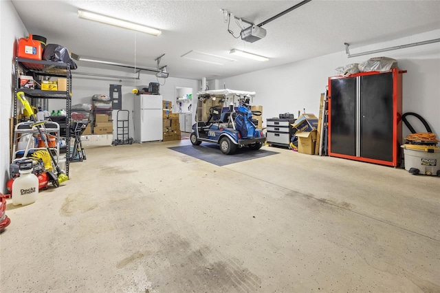 garage featuring a garage door opener and white fridge