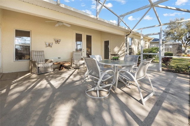 view of patio featuring a lanai and ceiling fan