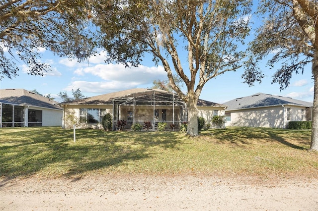 back of property with a lanai and a lawn