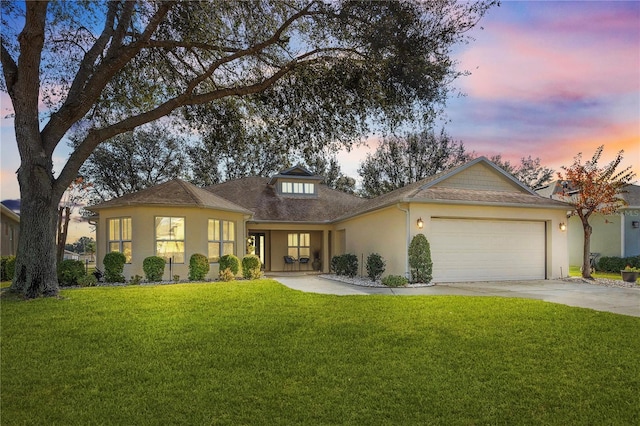 view of front of home featuring a garage and a lawn