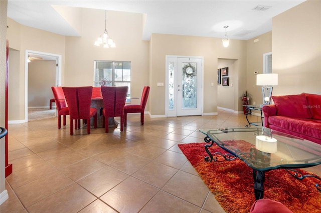 tiled living room featuring an inviting chandelier