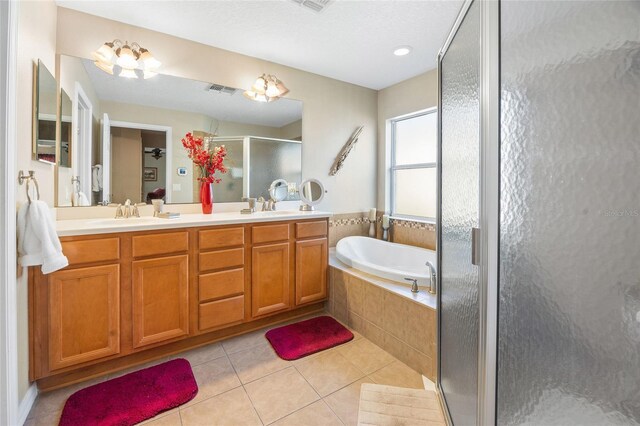 bathroom with tile patterned flooring, vanity, and independent shower and bath