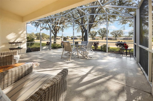 view of patio / terrace featuring glass enclosure