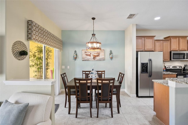 dining space featuring an inviting chandelier and light tile patterned floors