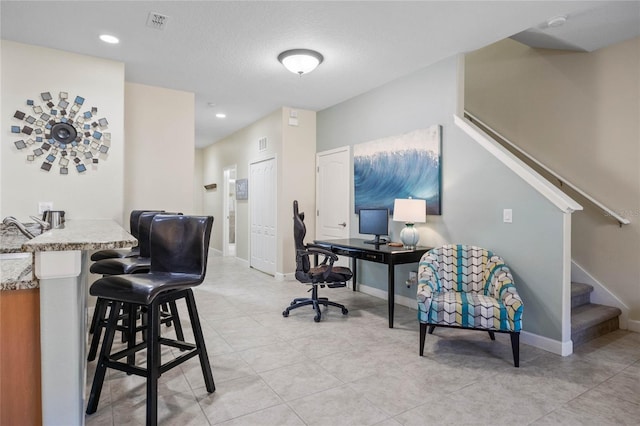 office area with a textured ceiling