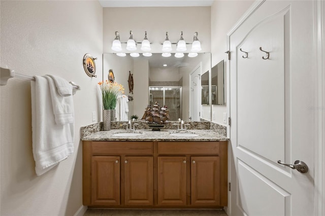 bathroom featuring vanity and an enclosed shower