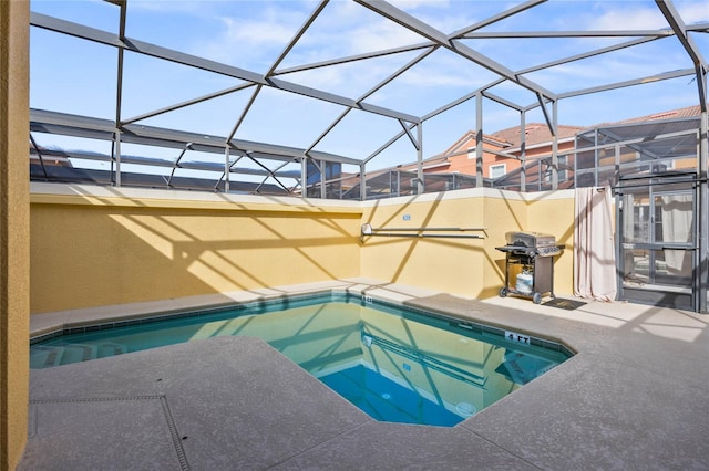 view of swimming pool featuring a grill, a hot tub, a patio, and glass enclosure