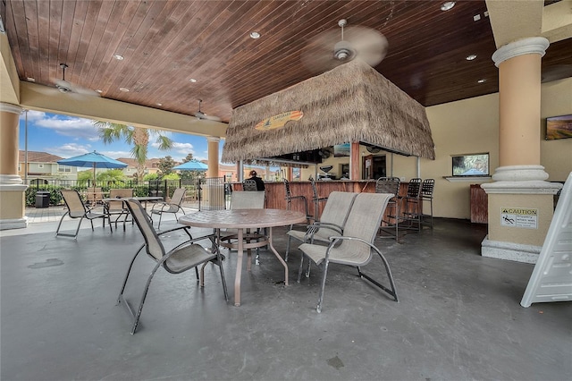 view of patio / terrace featuring ceiling fan and an outdoor bar