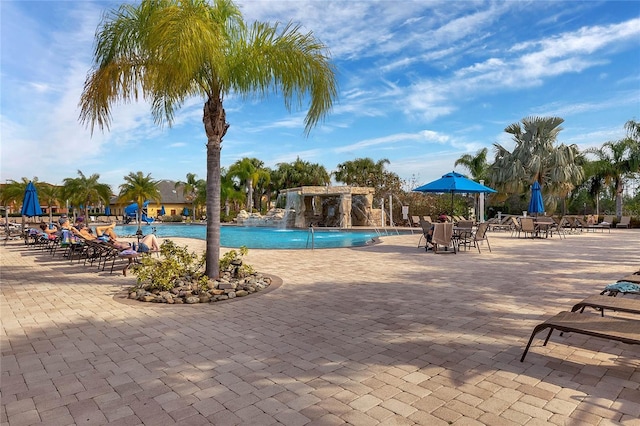 view of pool with a patio and pool water feature