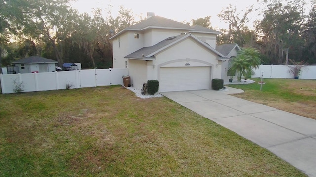 view of front facade with a garage and a front lawn