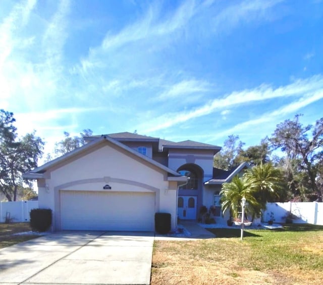 view of front of house with a garage and a front yard