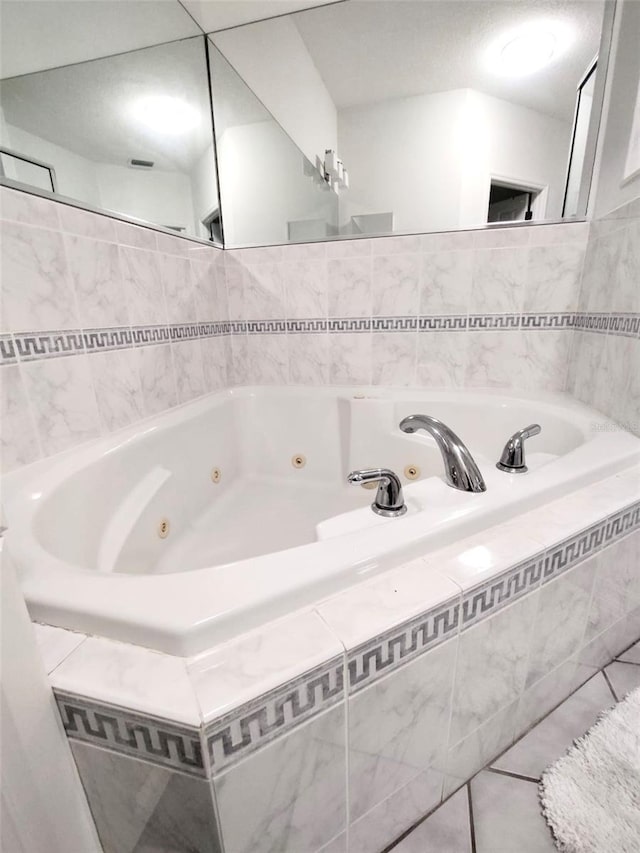 full bathroom with a whirlpool tub and tile patterned flooring