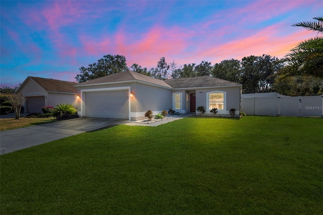 ranch-style home featuring a garage and a lawn