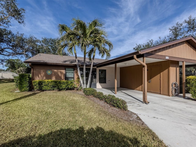 single story home featuring a carport and a front lawn