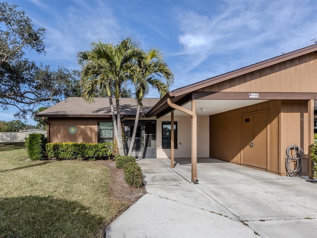 ranch-style house with a front lawn and a carport