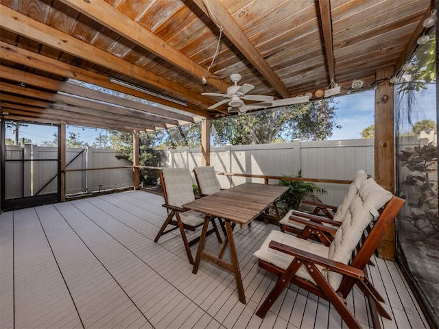 wooden deck with ceiling fan and a pergola