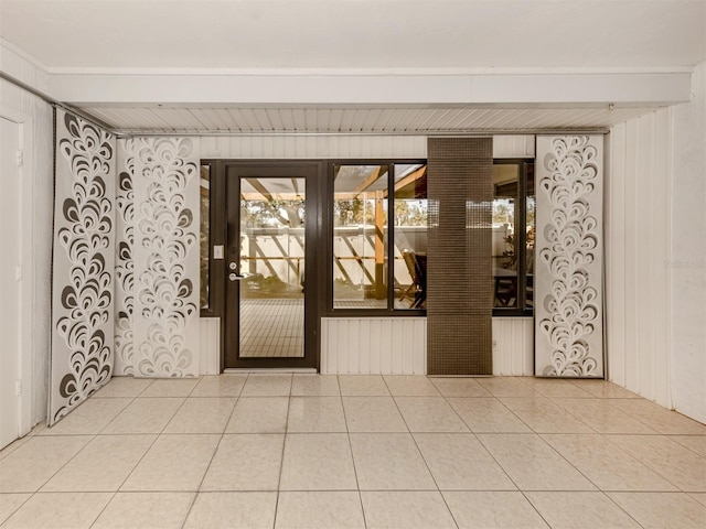 unfurnished room featuring tile patterned flooring and beamed ceiling