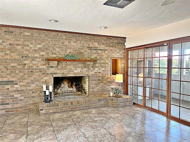 unfurnished living room featuring a fireplace and a textured ceiling