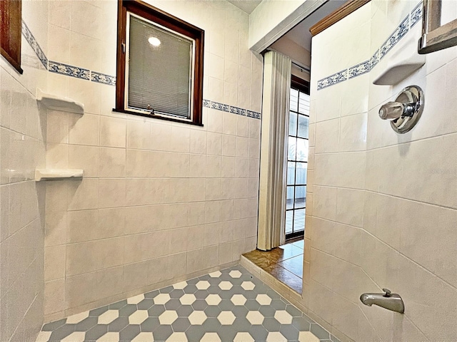 bathroom with tile walls and walk in shower