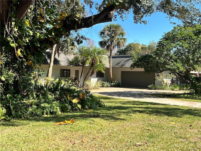 view of front of home with a garage and a front lawn