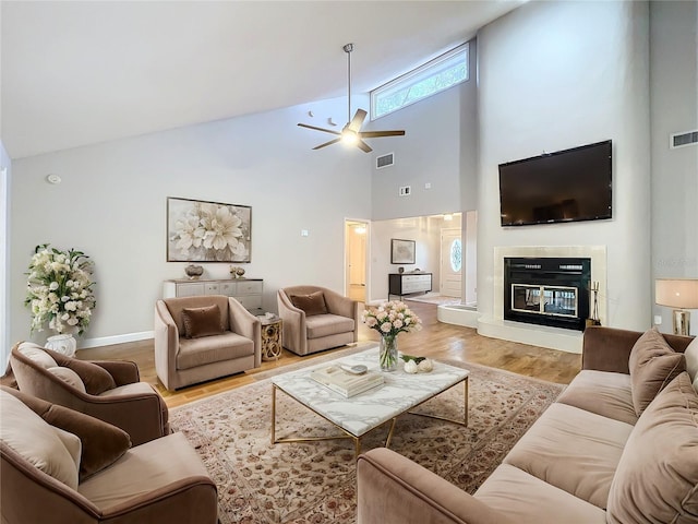 living room featuring ceiling fan and light hardwood / wood-style floors