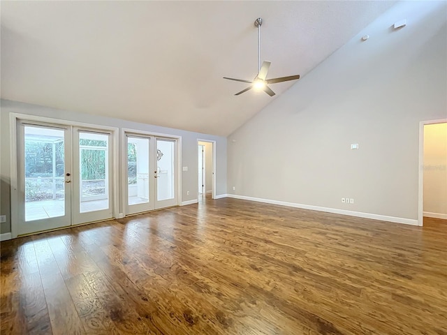 unfurnished living room with dark wood-type flooring, high vaulted ceiling, french doors, and ceiling fan