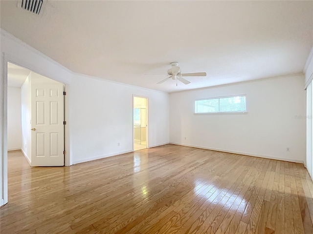 spare room featuring ornamental molding, ceiling fan, and light hardwood / wood-style flooring