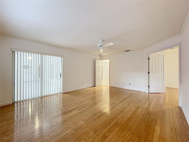 empty room featuring a textured ceiling, ceiling fan, and light wood-type flooring