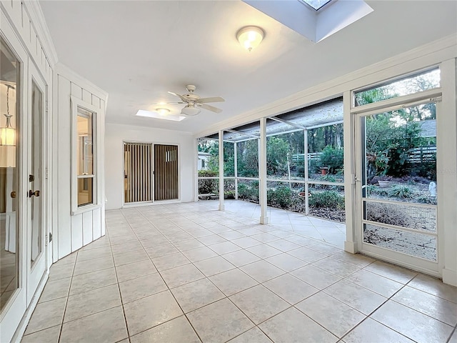 unfurnished sunroom featuring ceiling fan and a skylight