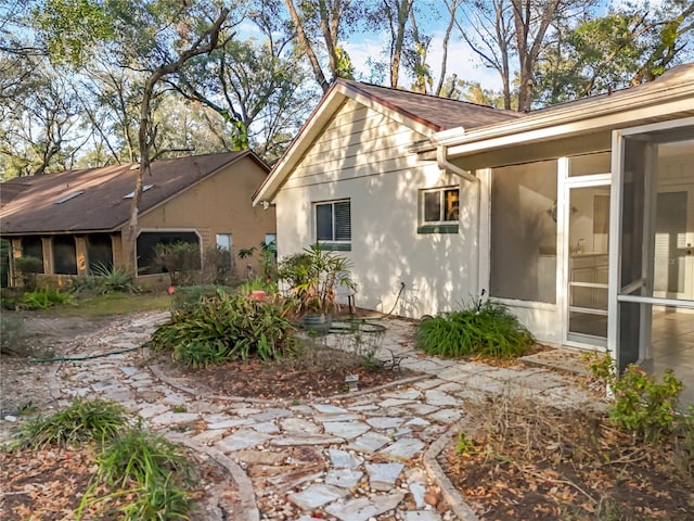 view of home's exterior with a sunroom