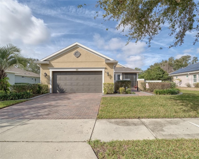 ranch-style house featuring a garage and a front lawn