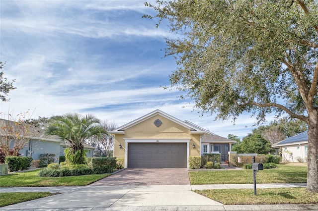 ranch-style house with a garage and a front yard