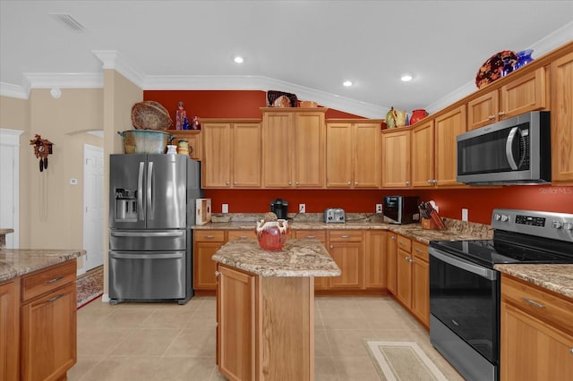 kitchen featuring crown molding, vaulted ceiling, appliances with stainless steel finishes, a kitchen island, and light stone countertops