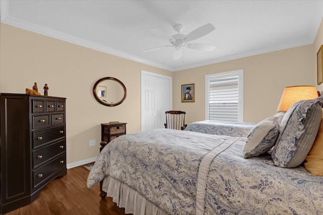 bedroom with crown molding, ceiling fan, dark hardwood / wood-style flooring, and a closet