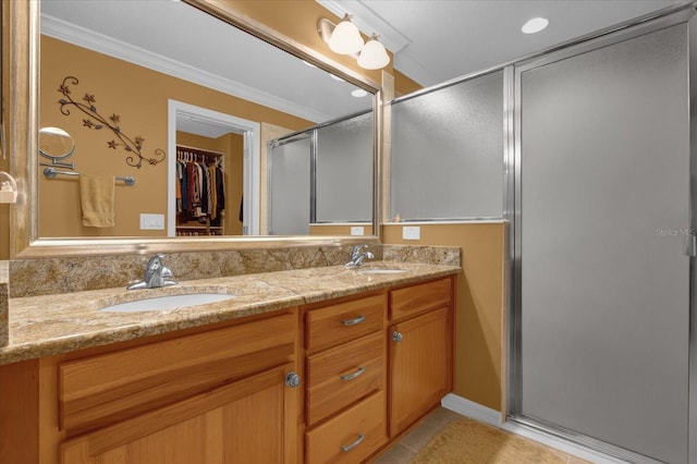 bathroom with vanity, tile patterned flooring, crown molding, and walk in shower