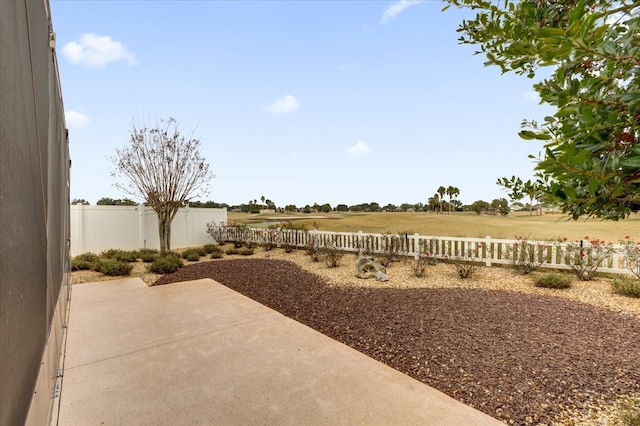 view of yard featuring a rural view and a patio area