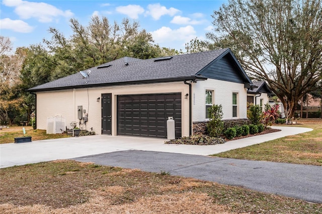 view of side of home featuring a yard and a garage