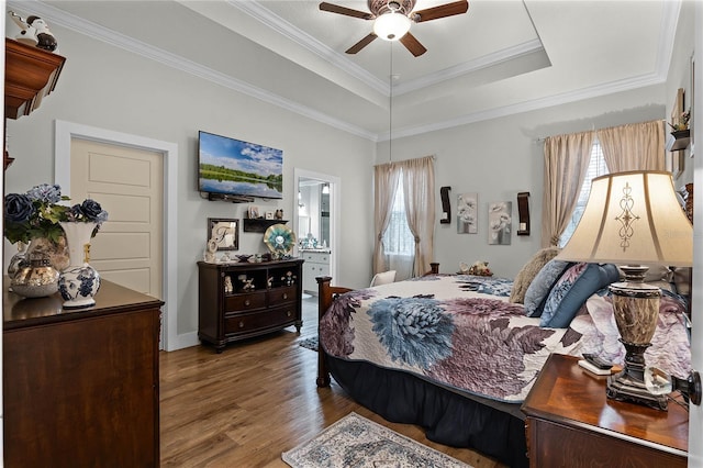 bedroom featuring a raised ceiling, wood-type flooring, crown molding, and multiple windows