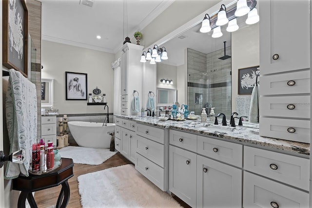 bathroom with crown molding, vanity, independent shower and bath, and hardwood / wood-style floors