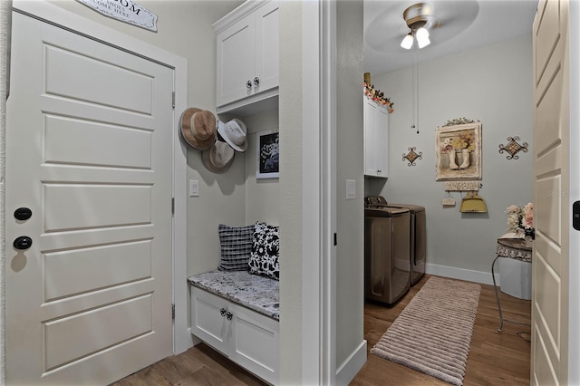 mudroom with separate washer and dryer, dark wood-type flooring, and ceiling fan