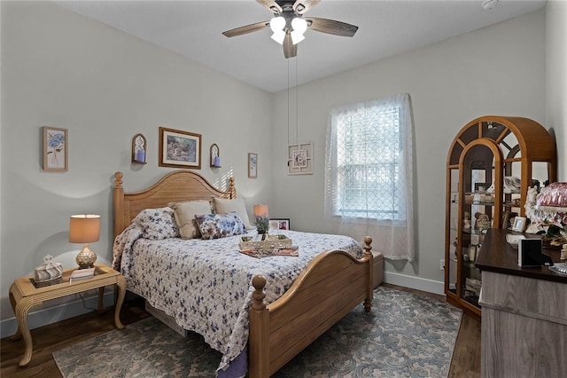 bedroom with ceiling fan and dark hardwood / wood-style floors