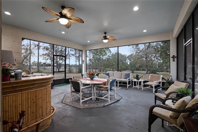 sunroom / solarium featuring ceiling fan