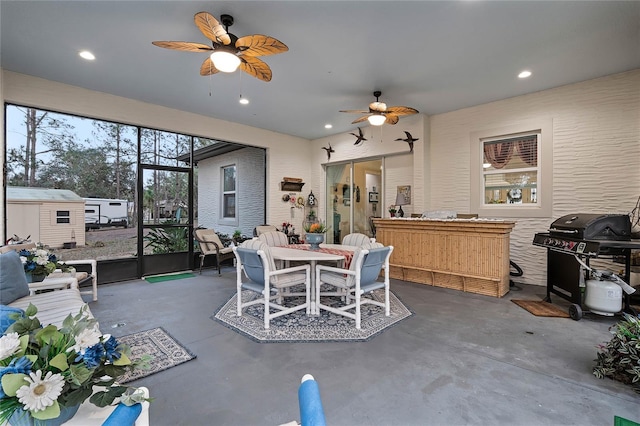 dining area with concrete flooring and ceiling fan