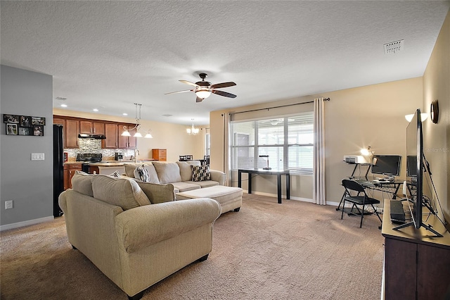 carpeted living room featuring sink, ceiling fan with notable chandelier, and a textured ceiling