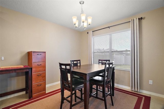 tiled dining room with an inviting chandelier