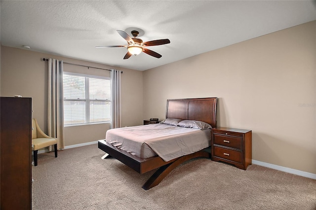 carpeted bedroom with a textured ceiling and ceiling fan