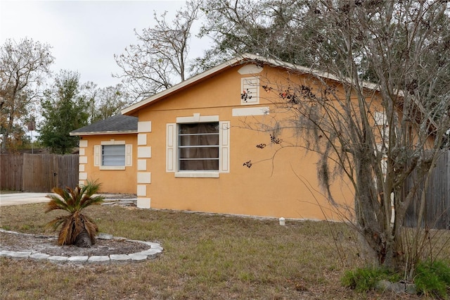 view of property exterior with a lawn