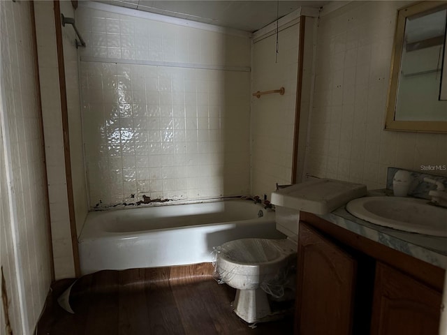 full bathroom with vanity, toilet, tile walls, and  shower combination