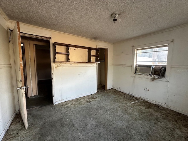 unfurnished bedroom featuring dark carpet and a textured ceiling