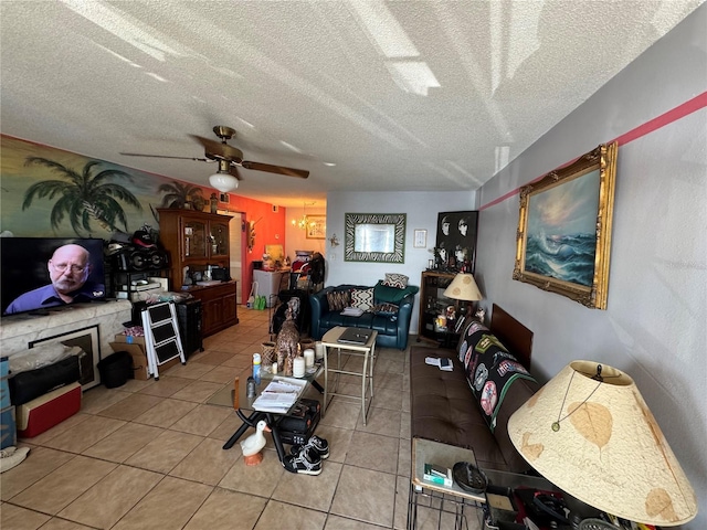 living room featuring ceiling fan, a textured ceiling, and light tile patterned floors